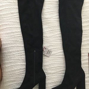 Knee high black heeled boots